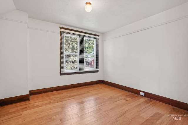 unfurnished room featuring light wood-type flooring and baseboards