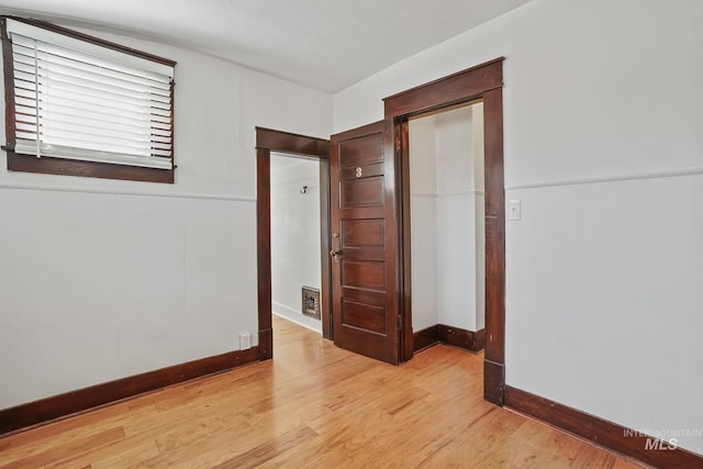 spare room featuring light wood-type flooring