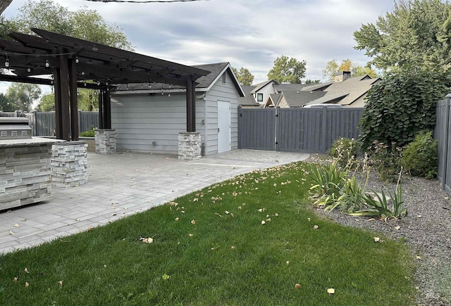 view of yard with a gate, a patio area, fence, and a pergola