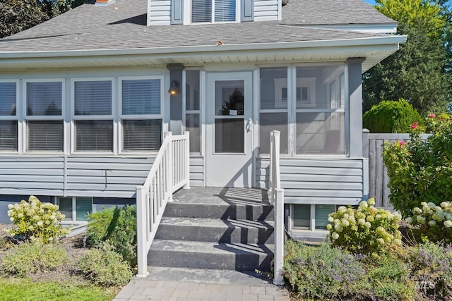 entrance to property with a shingled roof