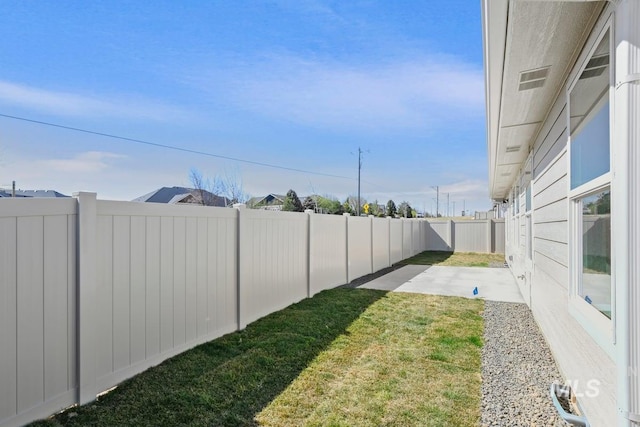 view of yard with a fenced backyard and a patio