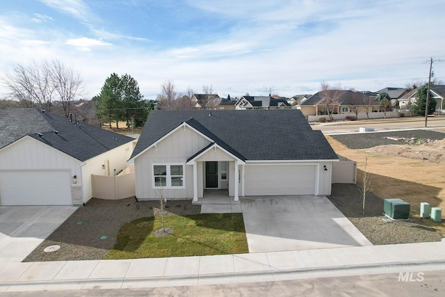 view of front of home with a garage, fence, concrete driveway, and roof with shingles