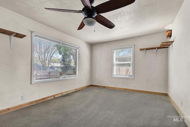 1219 N Indiana, Caldwell, ID 83605 - spare room featuring a textured ceiling, carpet, a ceiling fan, baseboards, and visible vents