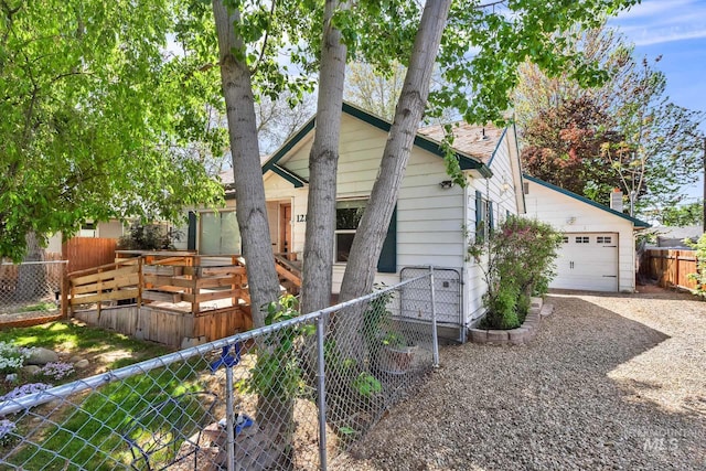 1219 N Indiana, Caldwell, ID 83605 - view of front of home featuring a detached garage, driveway, and fence private yard