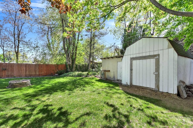 1219 N Indiana, Caldwell, ID 83605 - view of yard featuring fence, a storage unit, an outdoor structure, and a fire pit