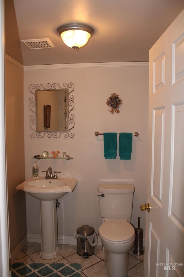 bathroom with tile flooring and toilet