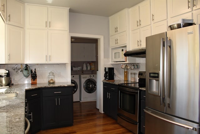 kitchen with backsplash, white cabinetry, dark wood-type flooring, washer and dryer, and appliances with stainless steel finishes