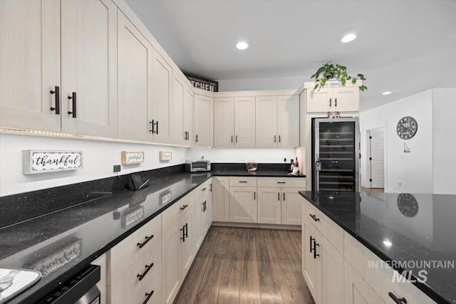 kitchen featuring wine cooler, dark wood-type flooring, dark stone counters, and dishwasher