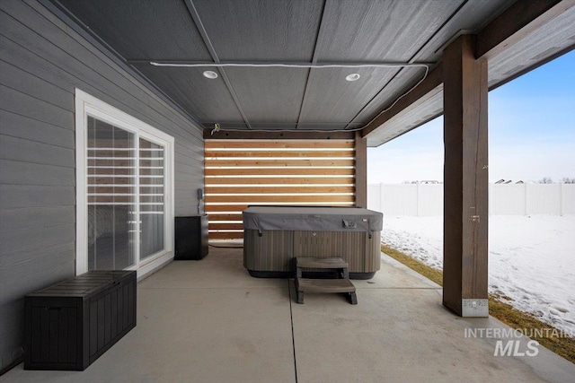 snow covered patio with a hot tub