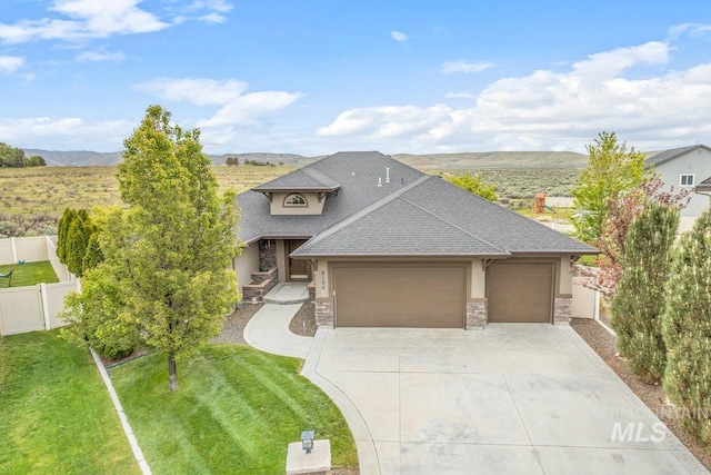 8194 S Bogus Ridge Way, Boise, ID 83716 - view of front facade with a shingled roof, a garage, stone siding, concrete driveway, and a mountain view