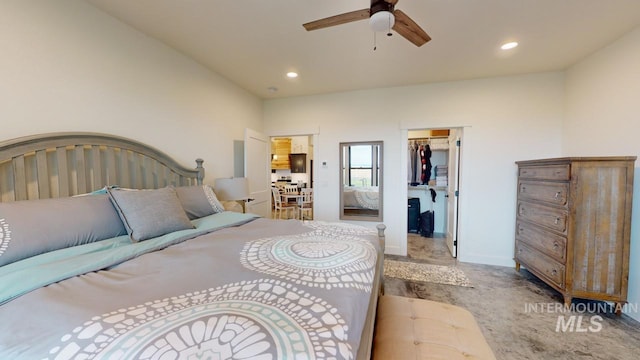 bedroom with carpet flooring, ceiling fan, a walk in closet, and a closet