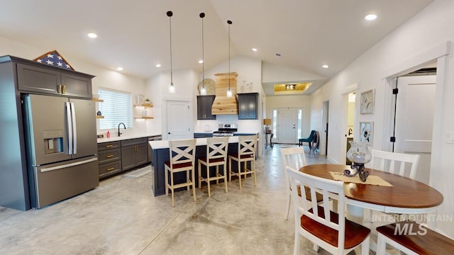 dining space with sink and lofted ceiling