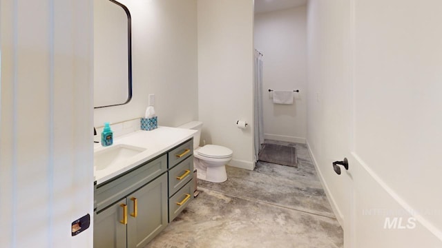 bathroom featuring vanity, toilet, and concrete floors