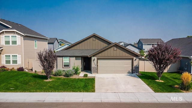 craftsman-style house featuring a front lawn, a garage, board and batten siding, and driveway