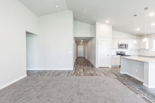 kitchen with light stone counters, baseboards, stainless steel appliances, decorative backsplash, and white cabinetry