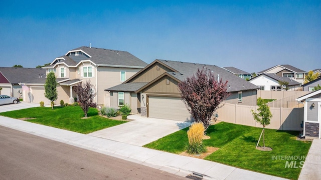 view of front of home with a front yard, fence, concrete driveway, a garage, and a residential view