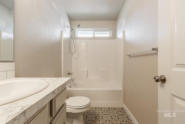 bathroom featuring vanity,  shower combination, tile patterned flooring, a textured ceiling, and a textured wall