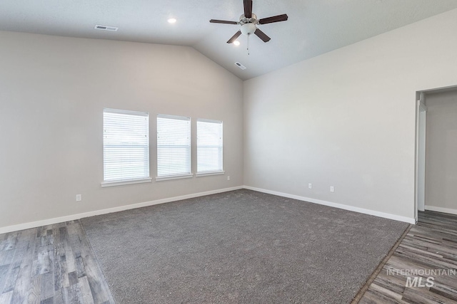 empty room featuring lofted ceiling, baseboards, visible vents, and ceiling fan