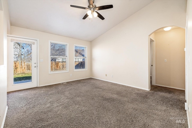 unfurnished room featuring vaulted ceiling, ceiling fan, and dark carpet