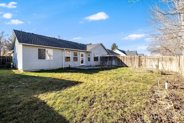 back of house with a yard and central AC unit