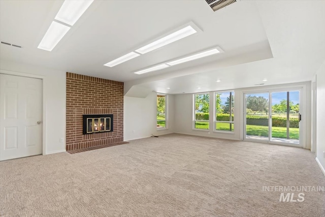 975 W Meander Ct, Eagle, ID 83616 - unfurnished living room featuring plenty of natural light, carpet floors, and a brick fireplace