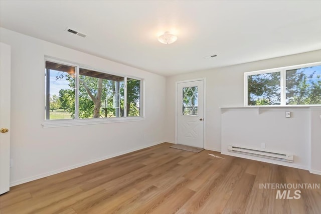 975 W Meander Ct, Eagle, ID 83616 - unfurnished room with baseboard heating, light wood finished floors, and baseboards