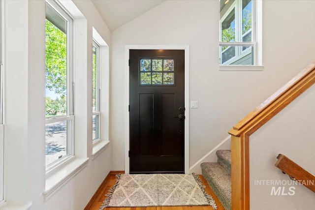 975 W Meander Ct, Eagle, ID 83616 - foyer entrance featuring plenty of natural light, lofted ceiling, wood finished floors, stairs, and baseboards