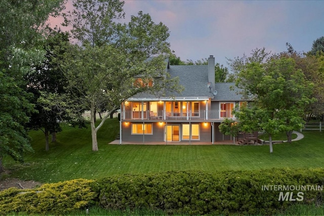 975 W Meander Ct, Eagle, ID 83616 - back of property at dusk with a lawn, a chimney, a patio, and a deck