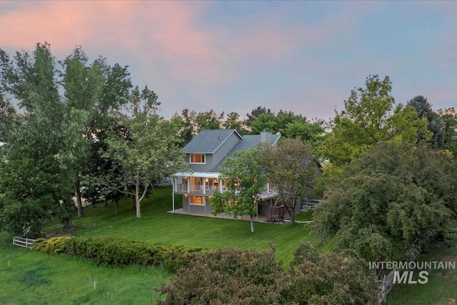 975 W Meander Ct, Eagle, ID 83616 - back of property at dusk featuring a wooden deck and a yard