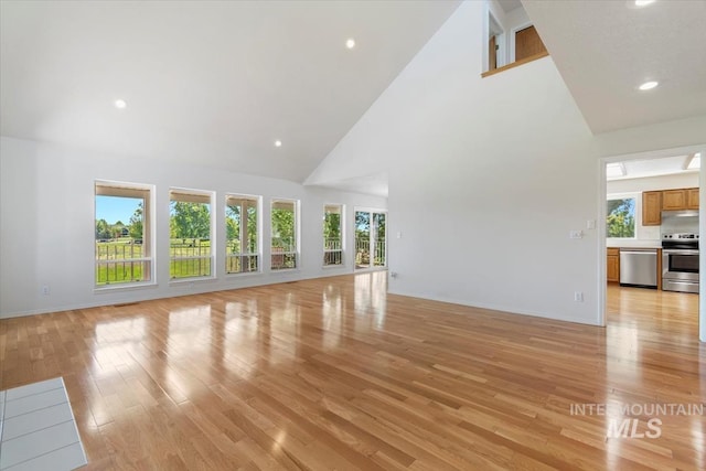 975 W Meander Ct, Eagle, ID 83616 - unfurnished living room featuring high vaulted ceiling, light wood-type flooring, plenty of natural light, baseboards, and recessed lighting