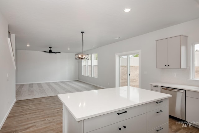 kitchen with dishwasher, decorative backsplash, light wood-type flooring, a kitchen island, and pendant lighting