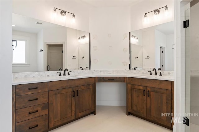 bathroom featuring vanity and a shower with shower door