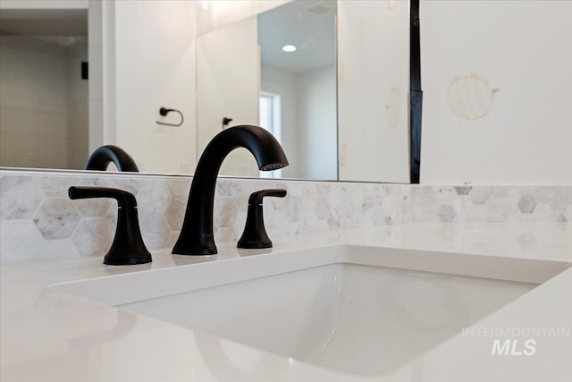 room details featuring decorative backsplash and vanity