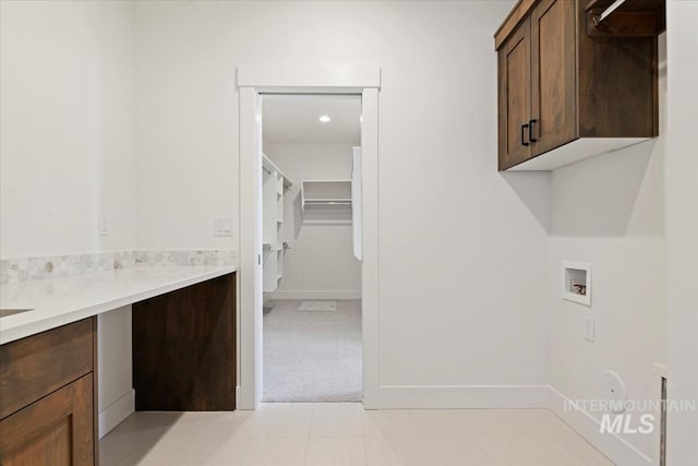 clothes washing area with cabinets, washer hookup, and light colored carpet