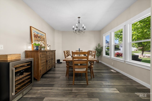 12384 S Abbott Downing Way, Nampa, ID 83686 - dining space with wine cooler, a chandelier, dark wood finished floors, and baseboards