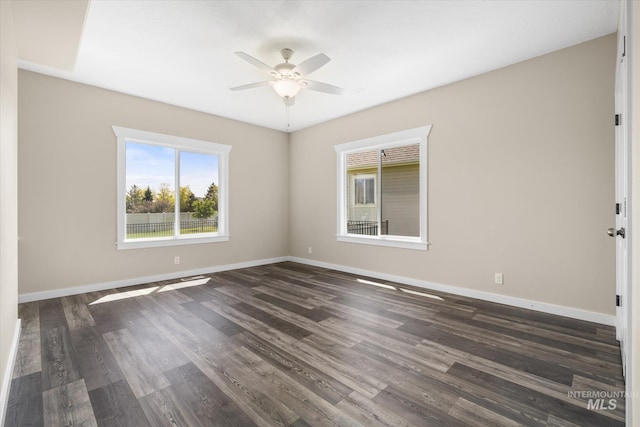 12384 S Abbott Downing Way, Nampa, ID 83686 - empty room with a ceiling fan, baseboards, and dark wood-type flooring