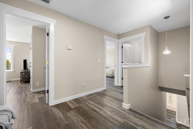 12384 S Abbott Downing Way, Nampa, ID 83686 - hallway featuring dark wood-style flooring and baseboards