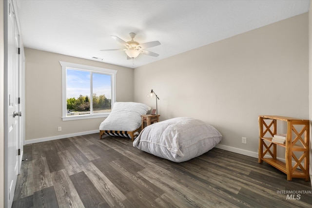 12384 S Abbott Downing Way, Nampa, ID 83686 - bedroom featuring dark wood-style flooring, baseboards, and a ceiling fan
