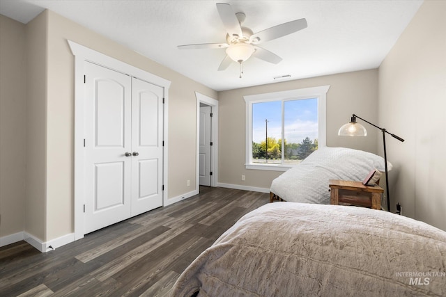 12384 S Abbott Downing Way, Nampa, ID 83686 - bedroom with dark wood finished floors, baseboards, a closet, and ceiling fan
