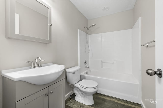 12384 S Abbott Downing Way, Nampa, ID 83686 - full bath featuring vanity, wood finished floors, toilet, shower / bath combination, and baseboards