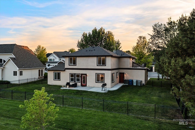 12384 S Abbott Downing Way, Nampa, ID 83686 - back of house at dusk with stucco siding and a patio area