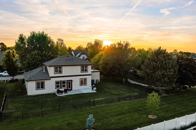 12384 S Abbott Downing Way, Nampa, ID 83686 - back of house at dusk with stucco siding and a patio