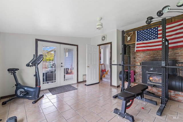 1125 Grelle Ave, Lewiston, ID 83501 - exercise area with french doors, baseboards, a wood stove, and tile patterned floors