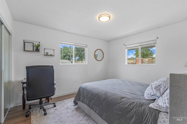 1125 Grelle Ave, Lewiston, ID 83501 - bedroom with wood finished floors, baseboards, a closet, and a desk