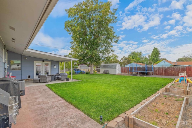 1125 Grelle Ave, Lewiston, ID 83501 - view of yard featuring a vegetable garden, an outdoor hangout area, a patio, and a trampoline