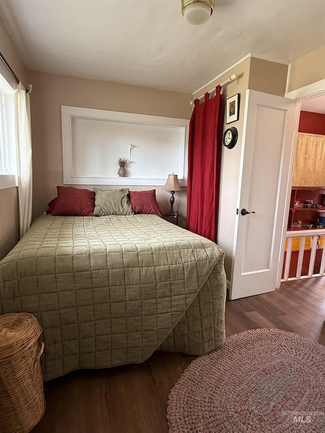 bedroom with dark wood-type flooring