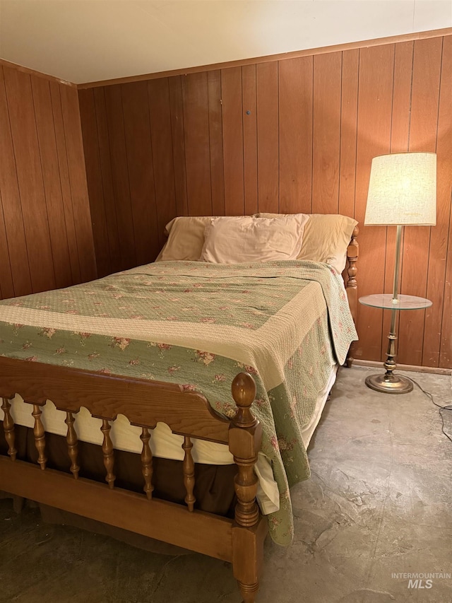 unfurnished bedroom featuring wood walls