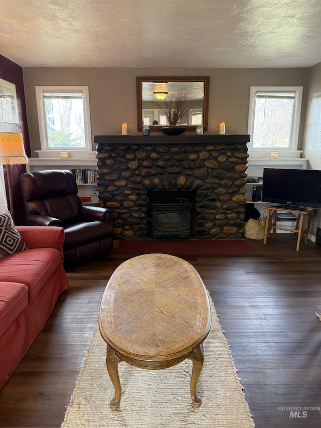 living room with a textured ceiling, wood finished floors, and a wealth of natural light