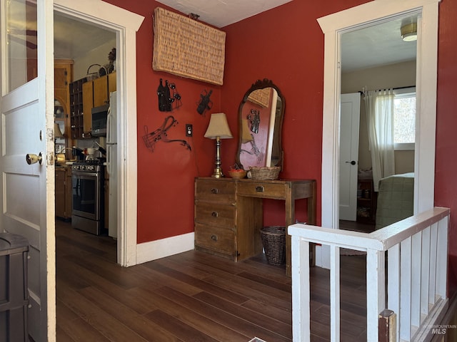 corridor with baseboards and dark wood-style flooring