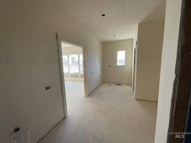 hallway featuring a textured ceiling